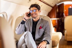 man on cell phone in private jet