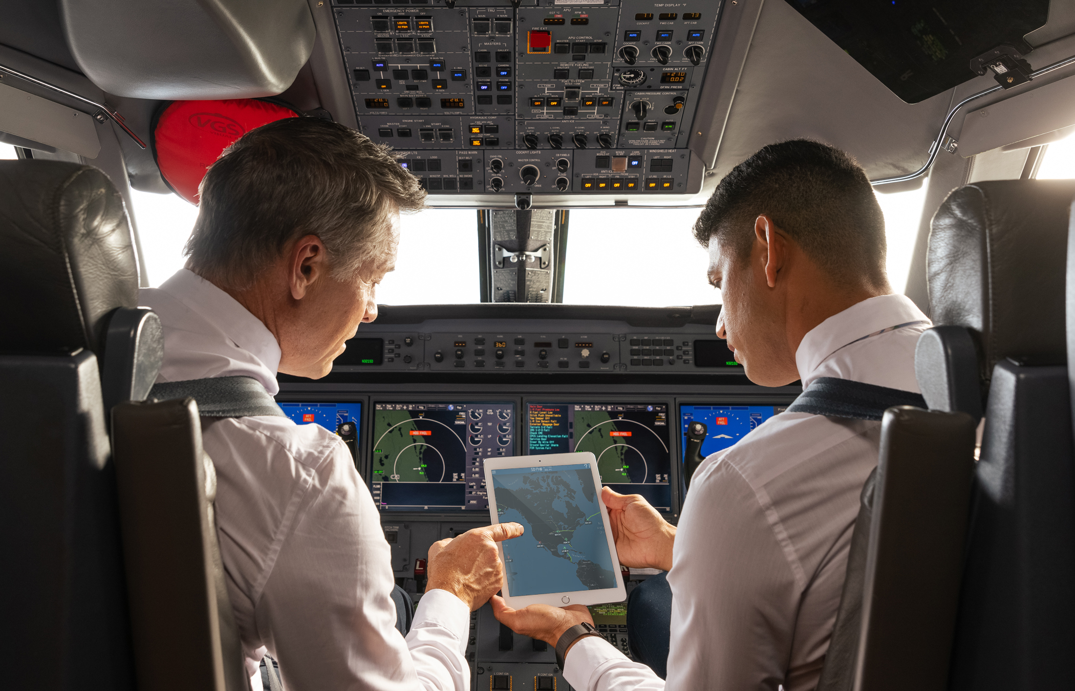 two pilots conversing in cockpit about flight